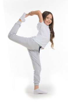 Yoga pose, girl standing stretching legs, leg split isolated on white background