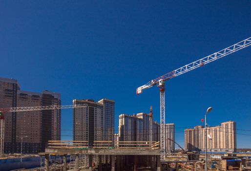 Construction of new real estate apartment buildings over blue sky