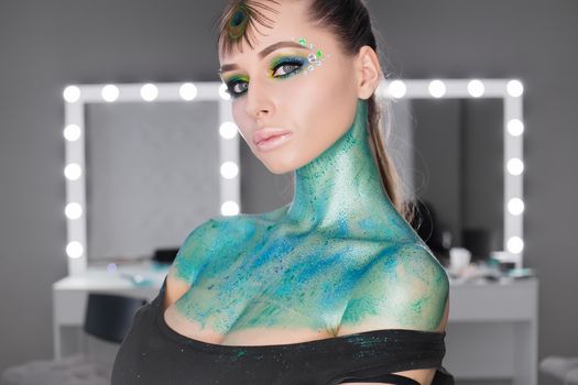 Fashion Art Portrait .Girl with green art makeup.