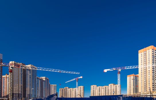 Construction of new real estate apartment buildings over blue sky