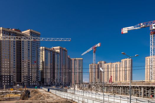 Construction of new real estate apartment buildings over blue sky