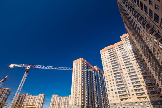 Construction of new real estate apartment buildings over blue sky