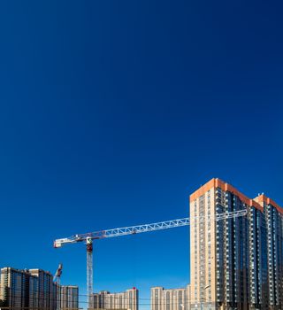 Construction of new real estate apartment buildings over blue sky