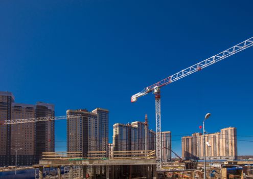 Construction of new real estate apartment buildings over blue sky