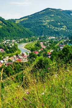 Rakhiv town in summer view from the hill. beautiful scenery in Carpathian mountains. Tisza river winds through the valley