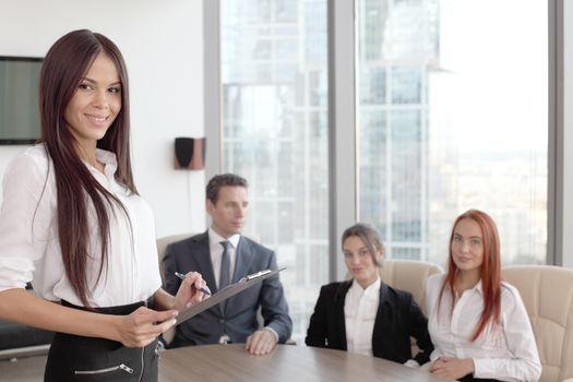 Group portrait of a professional business woman and team looking confidently at camera