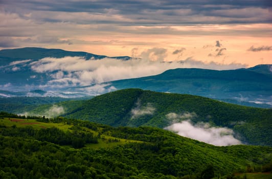 rising clouds above the mountain ridge. gorgeous springtime scenery at sunrise