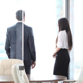 Rear view of business people looking at window