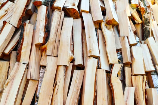 Chopped pine firewood pile background texture. Natural wood backdrop