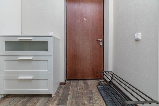 Empty entrance in modern apartment with shelves