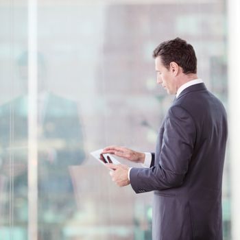 Businessman working with tablet and touching digital display