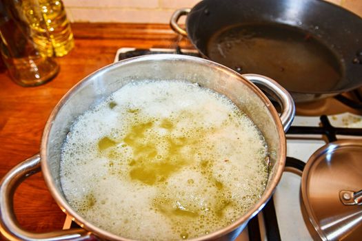 Cut potatoes boiling in stainless cooking pot. Cooking potatoes. 