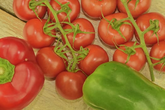 Fresh cherry tomatoes, red and green bell peppers on rustic wooden white background. White background. Close-up. Flat design. 