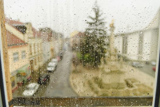 Town view through the window on a rainy day