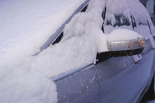 Closeup of a car covered with snow