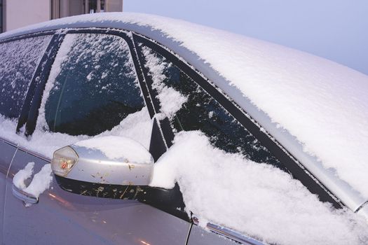 Closeup of a car covered with snow