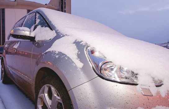 Closeup of a car covered with snow