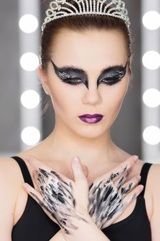 Fashion art studio portrait of beautiful elegant woman in black turtleneck. Hair is collected in high beam. Elegant ballet style.