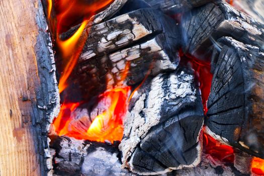 Big firewood burns closeup. Heat barbecue bright ash prepare with small flame