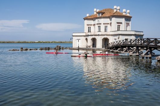NAPLES - APRIL 7, 2012: royal hunting house on the Fusaro Lake with canoes under the bridge, on April 7, 2012 in Naples, Italy