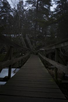 Bridge over a lake and stairway up a mountain, to a forest. Nackareservatet - nature reserve in Sweden