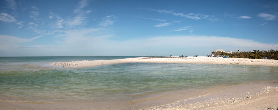 White sand beach and aqua blue water of Clam Pass in Naples, Florida in the morning.