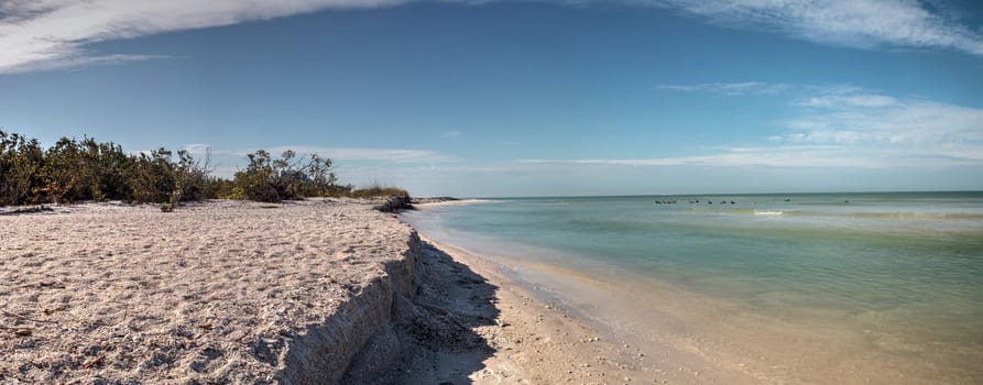 White sand beach and aqua blue water of Clam Pass in Naples, Florida in the morning.