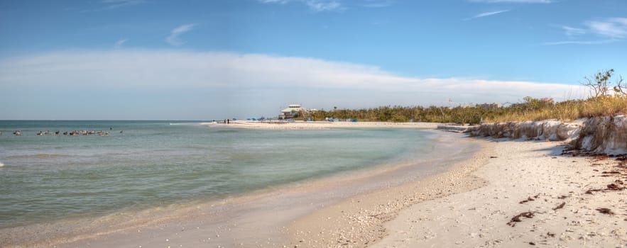 White sand beach and aqua blue water of Clam Pass in Naples, Florida in the morning.