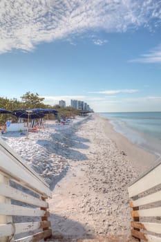 White sand beach and aqua blue water of Clam Pass in Naples, Florida in the morning.