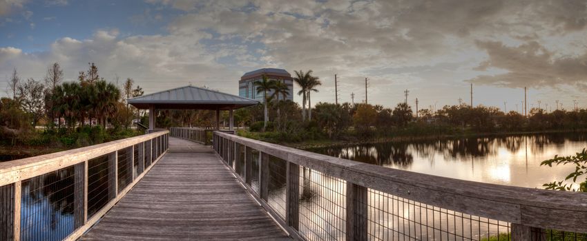 Sunset over Gazebo on a wooden secluded, tranquil boardwalk along a marsh pond in Freedom Park in Naples, Florida