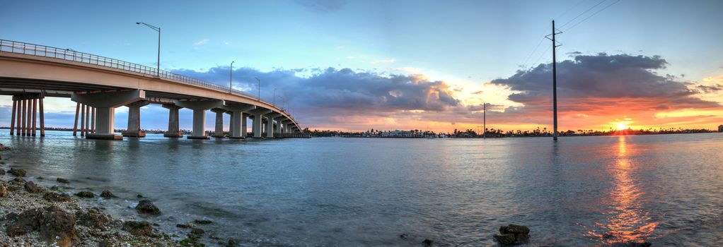 Sunset over the bridge roadway that journeys onto Marco Island, Florida over the bay.