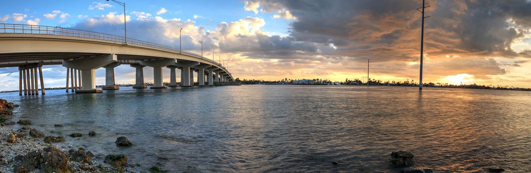 Sunset over the bridge roadway that journeys onto Marco Island, Florida over the bay.