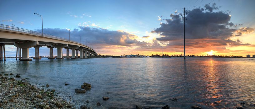Sunset over the bridge roadway that journeys onto Marco Island, Florida over the bay.