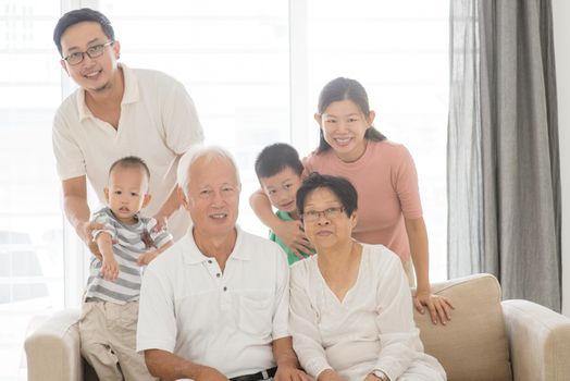 Happy Asian family portrait at home, multi generations indoor lifestyle.