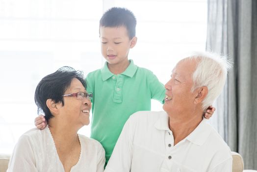 Portrait of Asian grandparents and grandson at home, old senior retired people and child indoor lifestyle.
