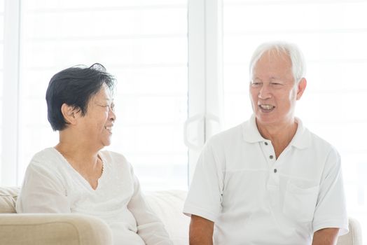 Portrait of happy Asian elderly couple talking at home, old senior retired people indoor lifestyle.