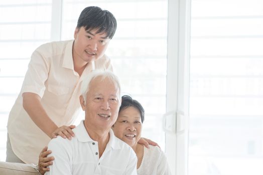 Portrait of happy Asian family at home, old parents and mature son indoor lifestyle.