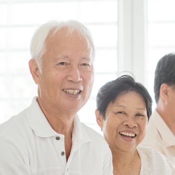 Portrait of happy Asian elderly couple at home, candid old senior retired people indoor lifestyle.