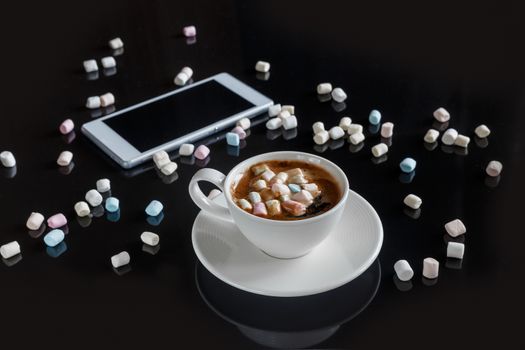marshmallow in a white cup on a dark background
