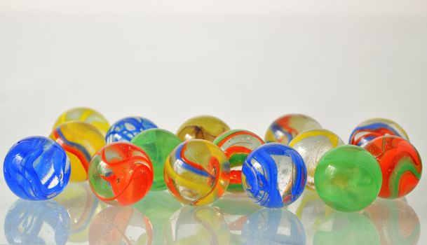 close up of a bunch of marbles on glass table