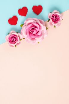 Blank paper note and roses on color paper background