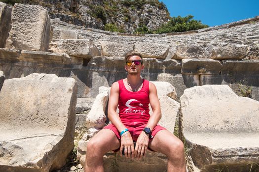 Young man at theatre in Myra ancient city of Antalya in Turkey.