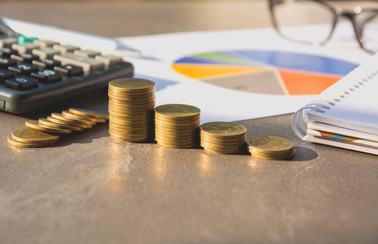 Stock financial indices with stack coin and calculator. Financial stock market in accounting market economy analysis.