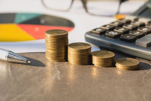 Stock financial indices with stack coin and calculator. Financial stock market in accounting market economy analysis.