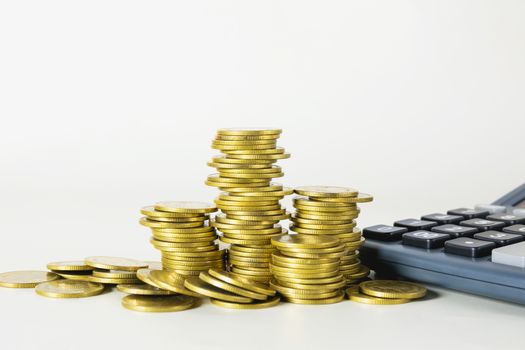 Stock financial indices with stack coin and calculator. Financial stock market in accounting market economy analysis.