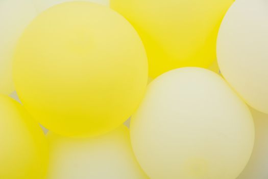 Close up of bunches and groups of yellow helium balloons.