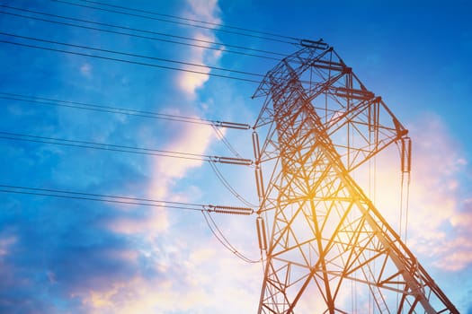 High voltage pole on blue sky background. High voltage tower.