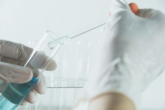 Researcher with glass laboratory chemical test tubes with liquid for analytical , medical, pharmaceutical and scientific research concept.