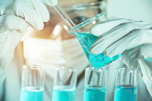 Researcher with glass laboratory chemical test tubes with liquid for analytical , medical, pharmaceutical and scientific research concept.