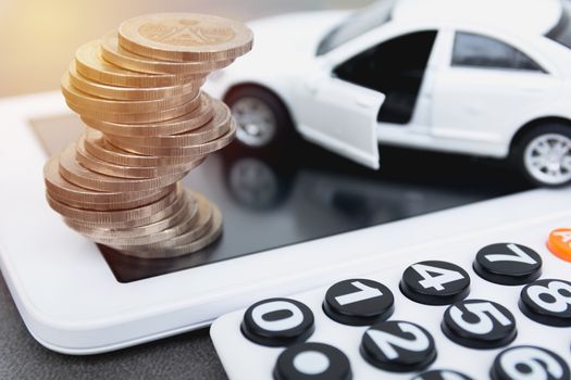 Car insurance with coins and calculator, car services. Car insurance and financial concept.